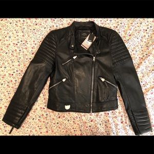 Black sheep leather jacket with silver zippers.
